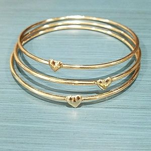 Gold bangles with gold heart.